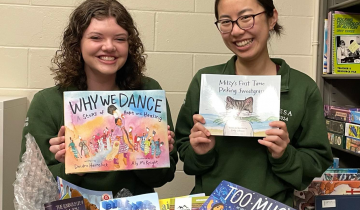 Elizabeth Li (right) and Haley Allen (left) holding children's books