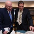Mr. Schulich and Principal Woolf examine a rare volume